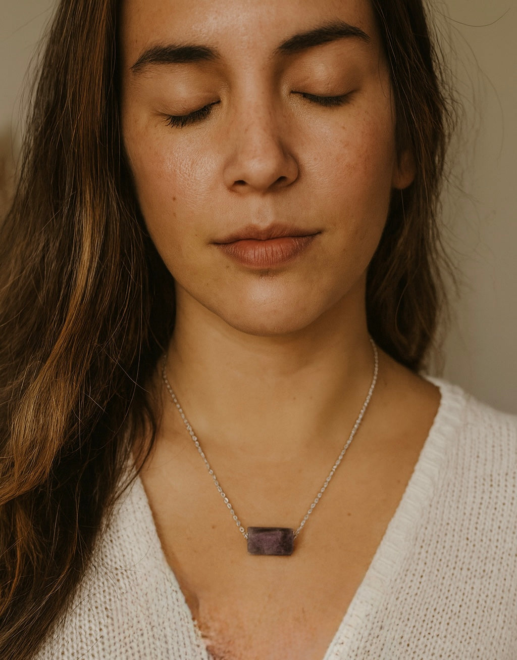 Woman wearing a lepidolite necklace